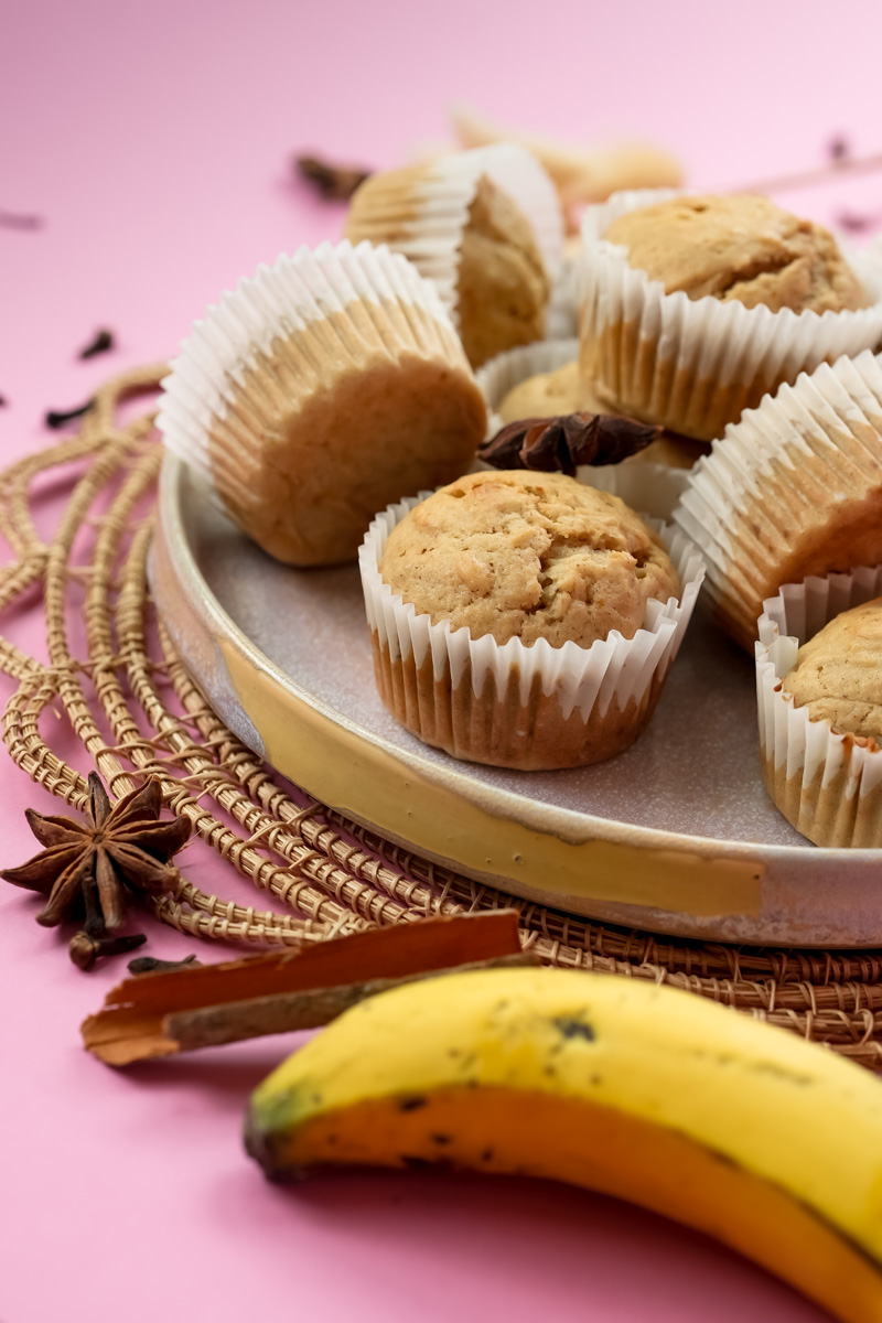 Homemade mini banana muffins displayed with cinnamon and star anise