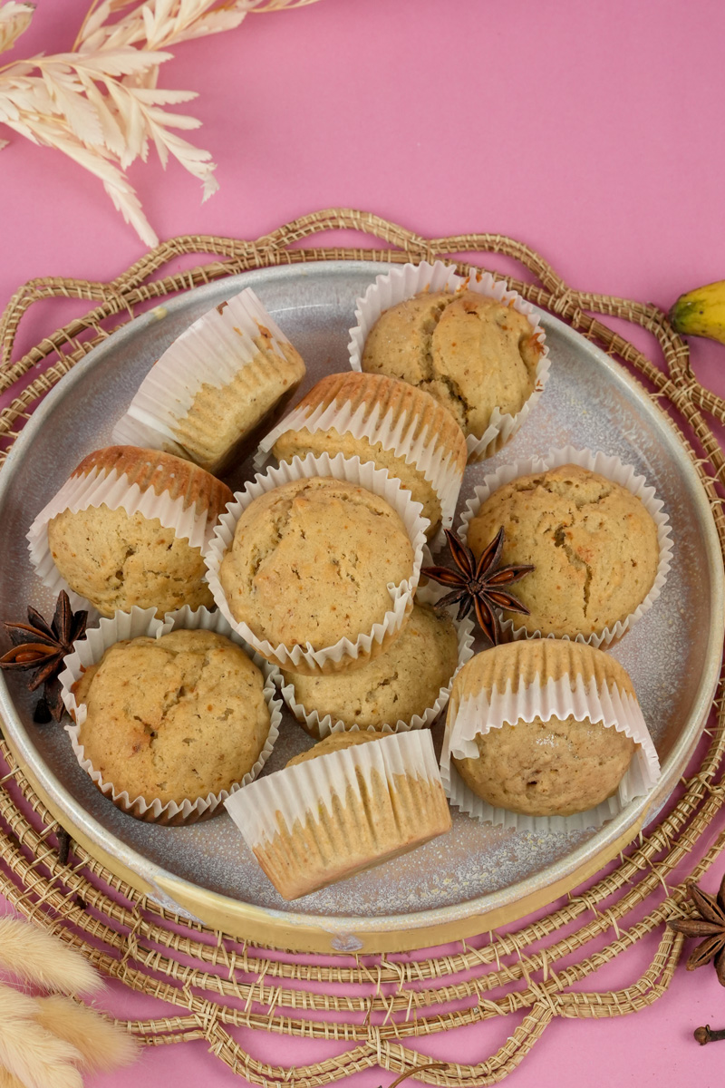 Mini banana muffins served on ceramic plate with star anise and cinnamon