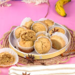 Mini banana muffins with ripe banana and spices on woven placemat