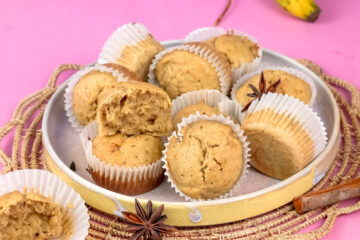 Mini banana muffins with ripe banana and spices on woven placemat