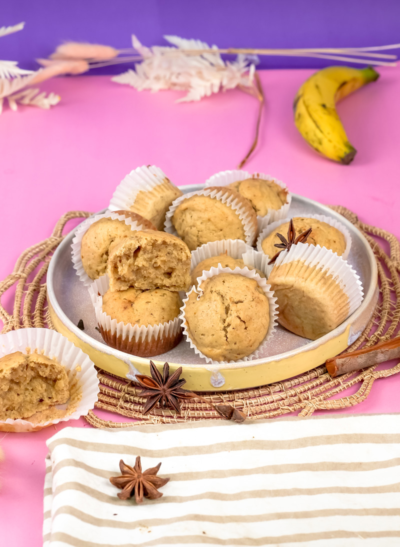 Mini banana muffins with ripe banana and spices on woven placemat