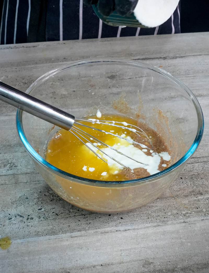 Mixing wet ingredients for mini banana muffins with whisk