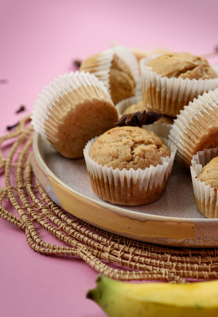 Homemade mini banana muffins displayed with cinnamon and star anise