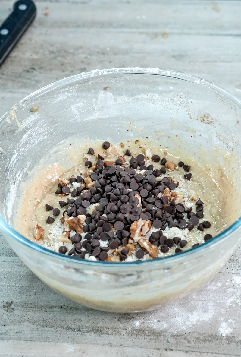 Adding chocolate chips to banana protein muffin batter
