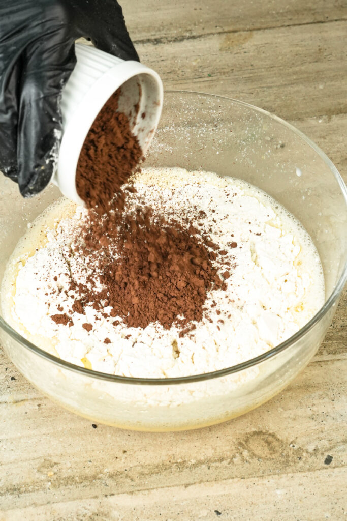 Adding cocoa powder to double chocolate muffin batter