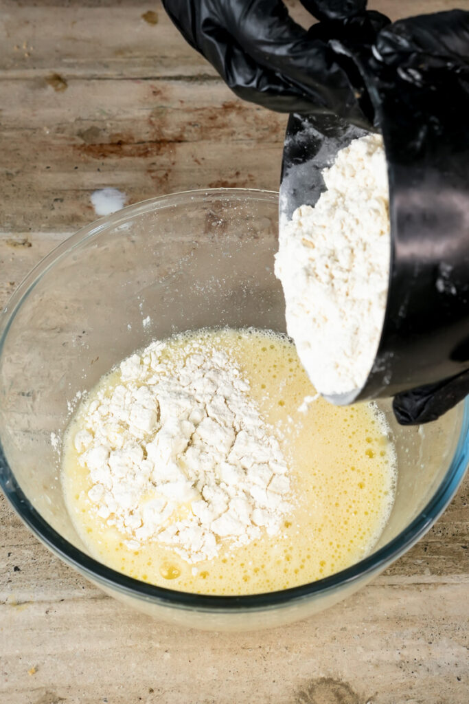 Adding flour to wet ingredients for pistachio muffin batter