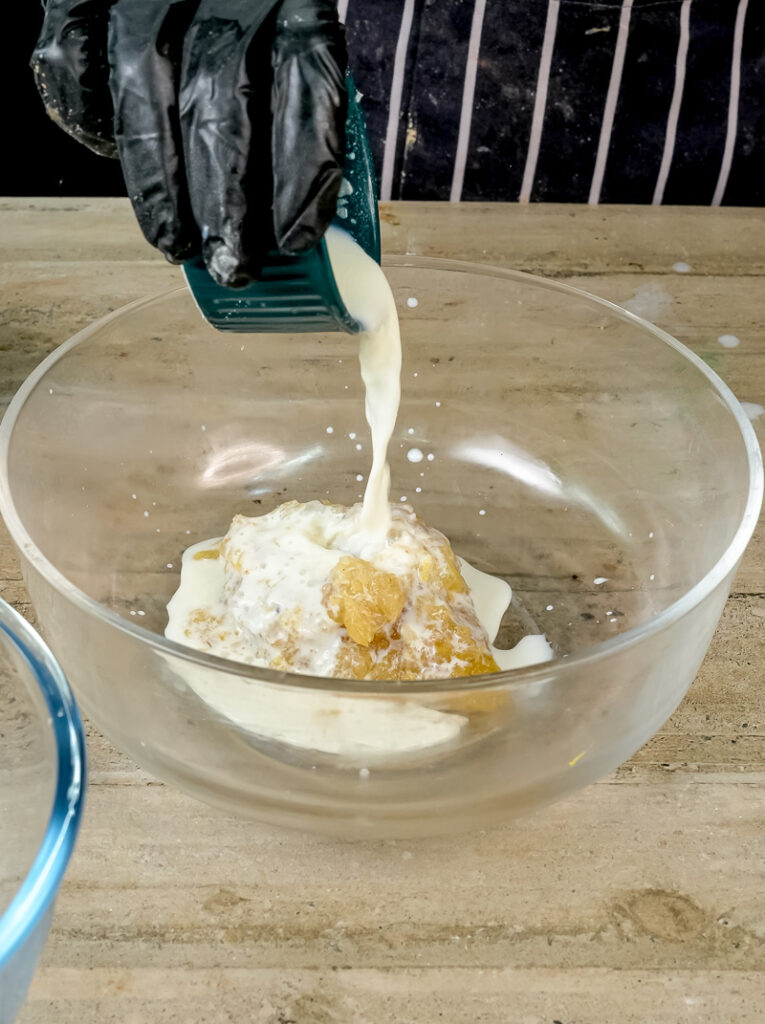 Adding milk to applesauce mixture for moist applesauce muffins