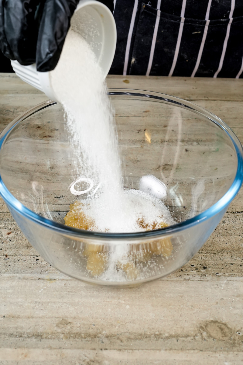 Adding sugar to mixing bowl for homemade oatmeal muffins