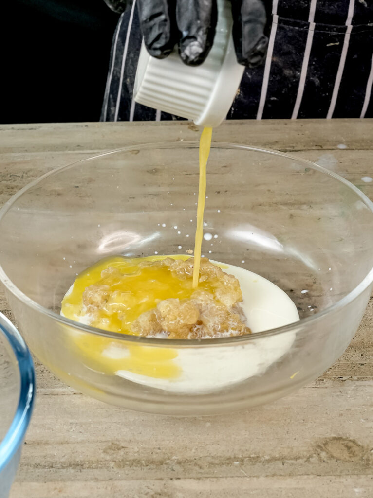 Pouring oil into applesauce muffin wet ingredients