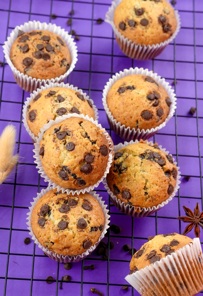 Array of banana protein muffins with chocolate chips and star anise.