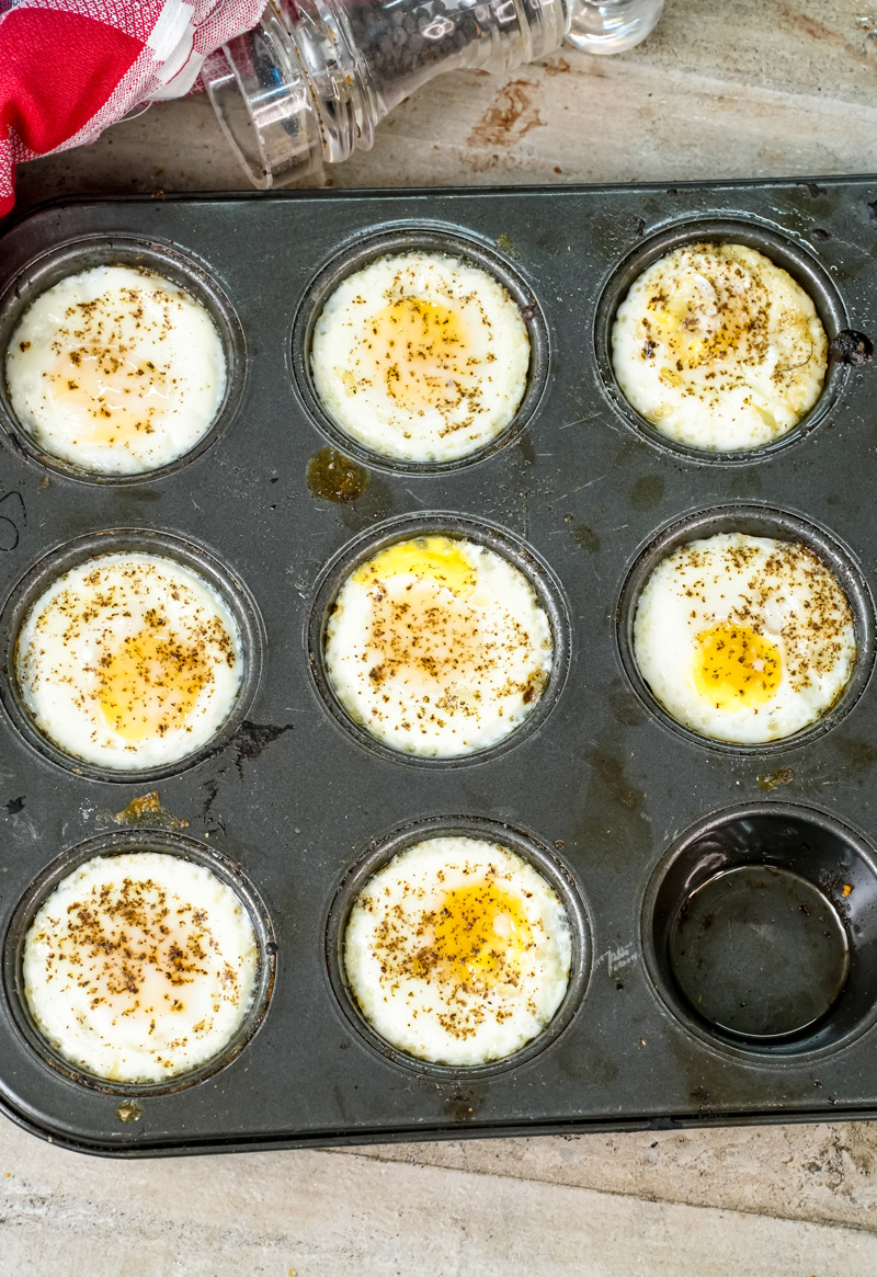 Baked egg cups in muffin tin with seasoning