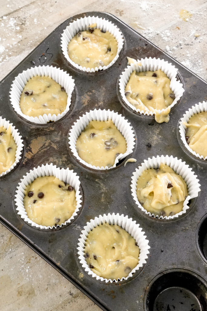 Banana chocolate chip muffin batter in paper liners ready for baking