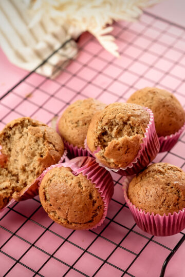 Banana muffins with one split open showing interior crumb
