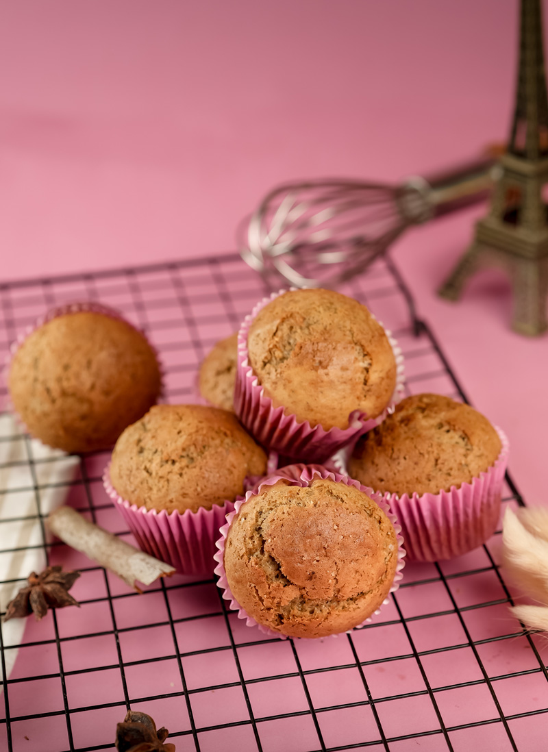 Banana muffins on cooling rack with metal whisk