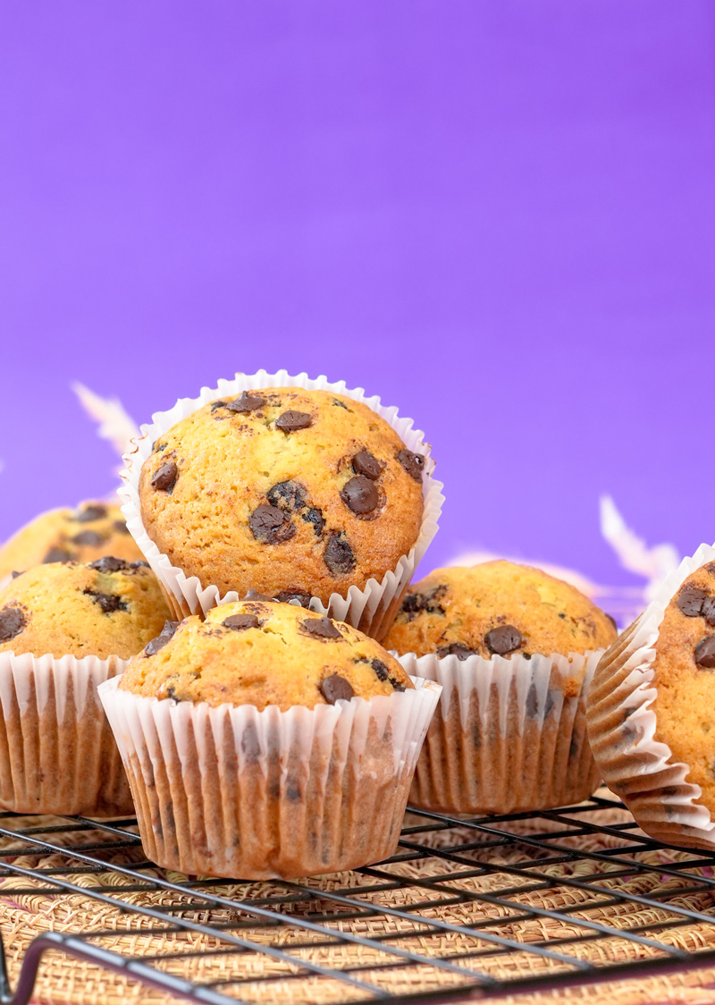 Stacked banana protein muffins with chocolate chips.