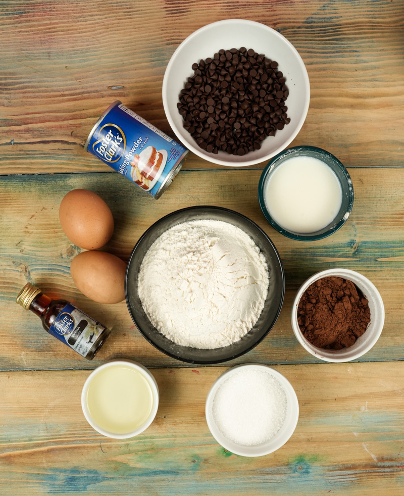 Double chocolate muffin ingredients on wooden surface