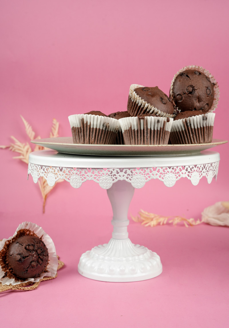 Double chocolate muffins display with pink background and white cake stand