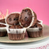 Double chocolate muffins with chocolate chips on decorative cake stand