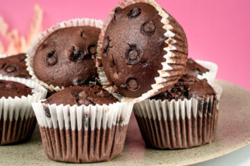 Double chocolate muffins with chocolate chips on decorative cake stand