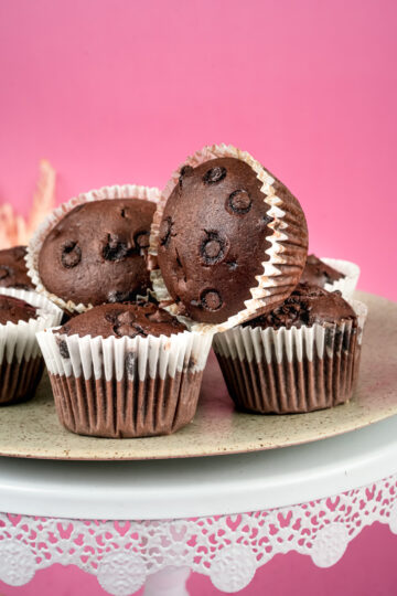 Double chocolate muffins with chocolate chips on decorative cake stand