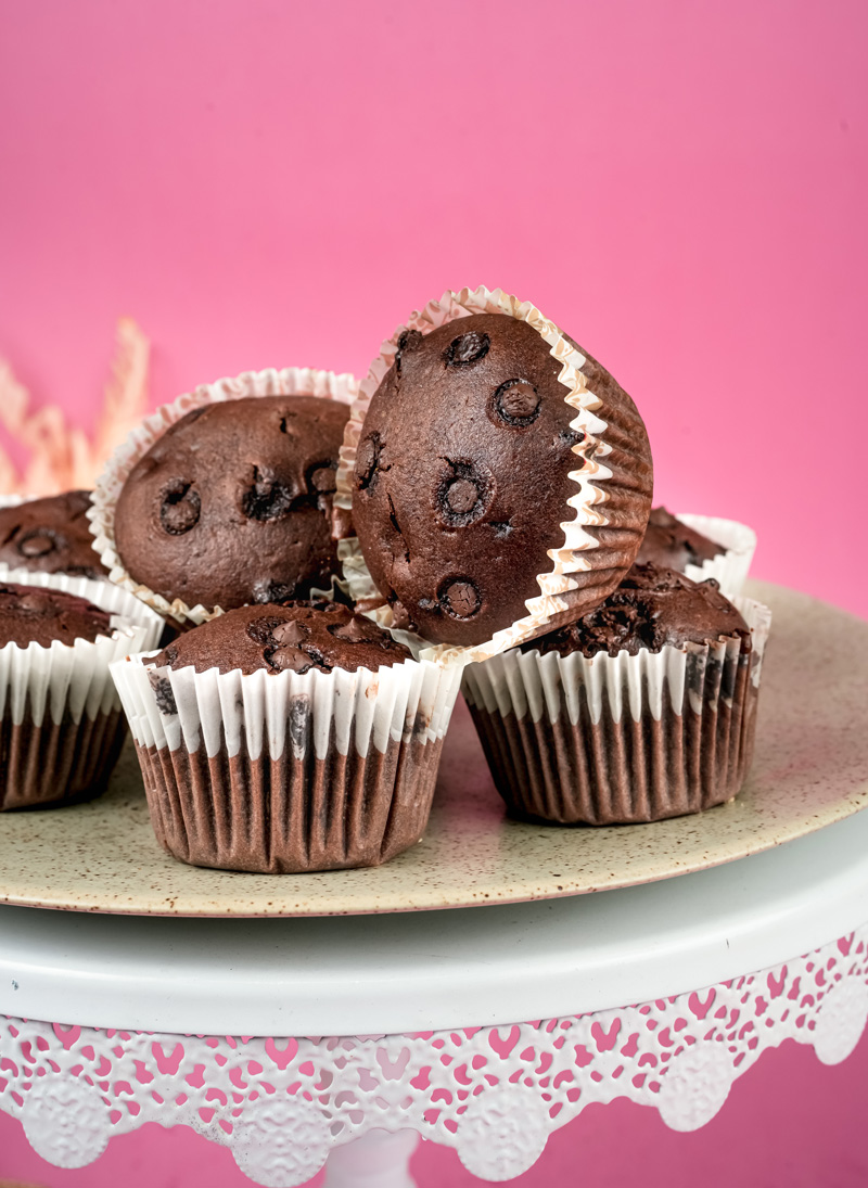 Double chocolate muffins with chocolate chips on decorative cake stand