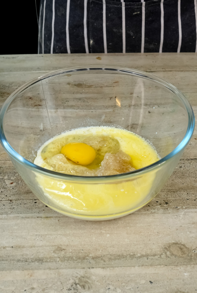 Egg and wet ingredients in glass bowl for oatmeal muffin batter