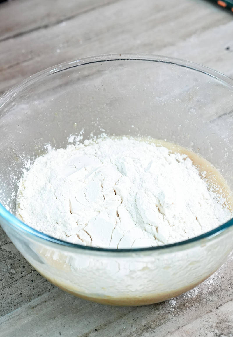 Flour in glass mixing bowl for banana muffin batter