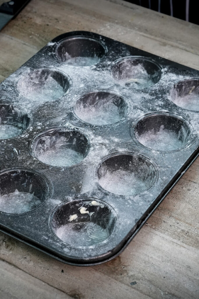 Floured muffin tin ready for cinnamon muffin batter