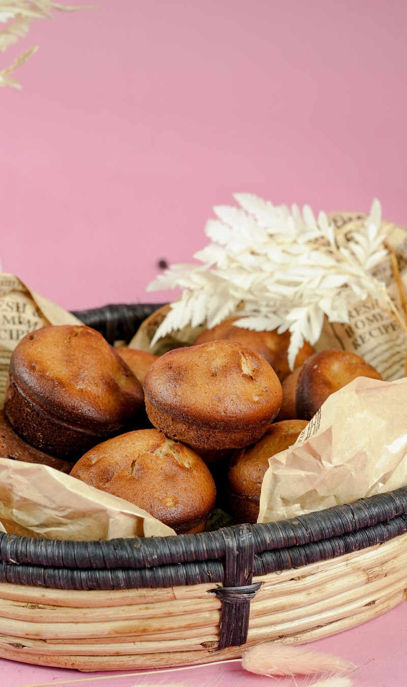 Freshly baked cinnamon muffins in a wicker basket lined with paper