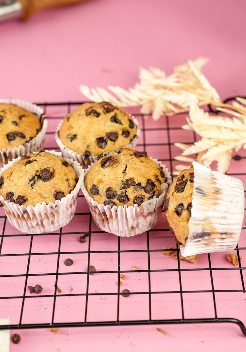 Homemade banana chocolate chip muffins cooling on wire rack