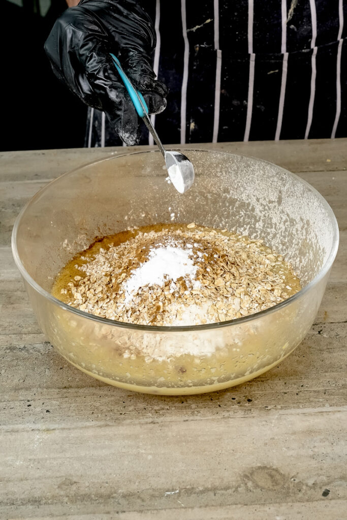 Measuring baking soda for healthy applesauce muffin recipe