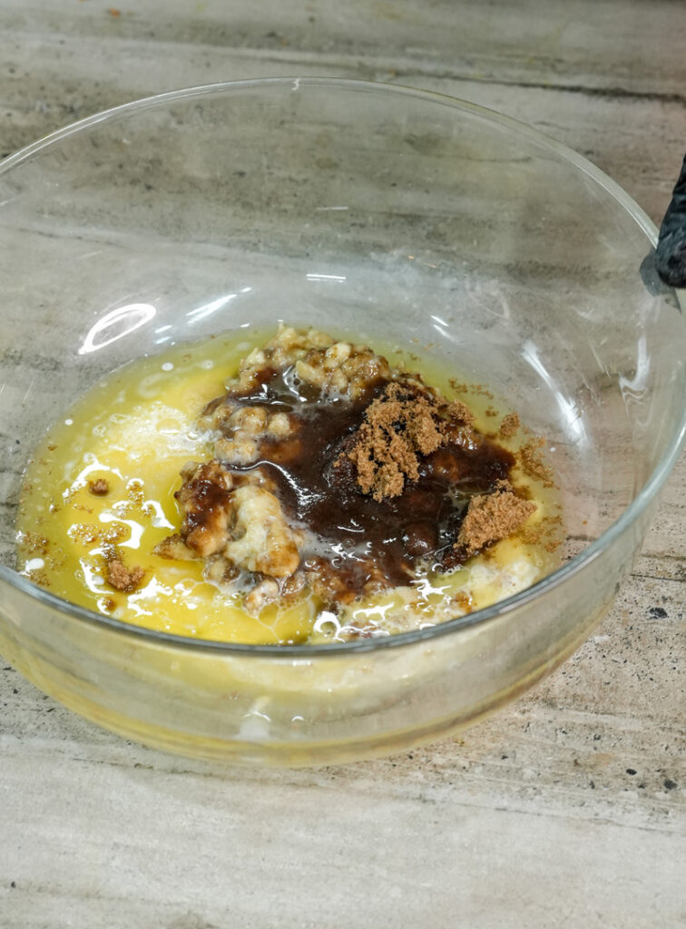 Mixing vanilla extract into banana walnut muffin batter