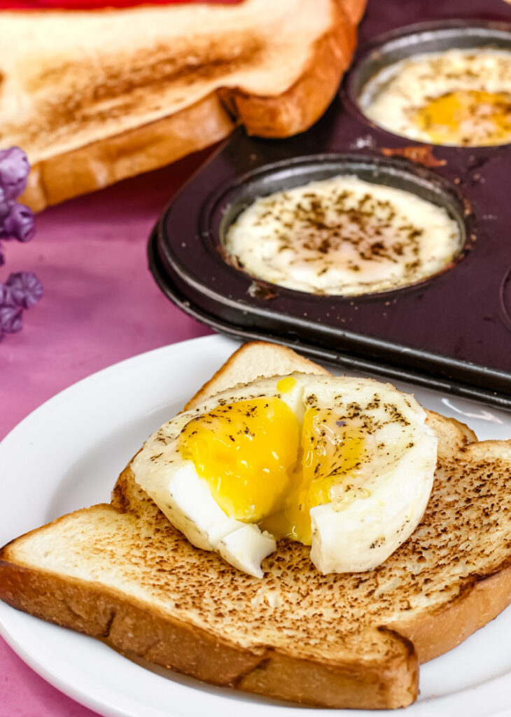Muffin tin baked egg with runny yolk on toast