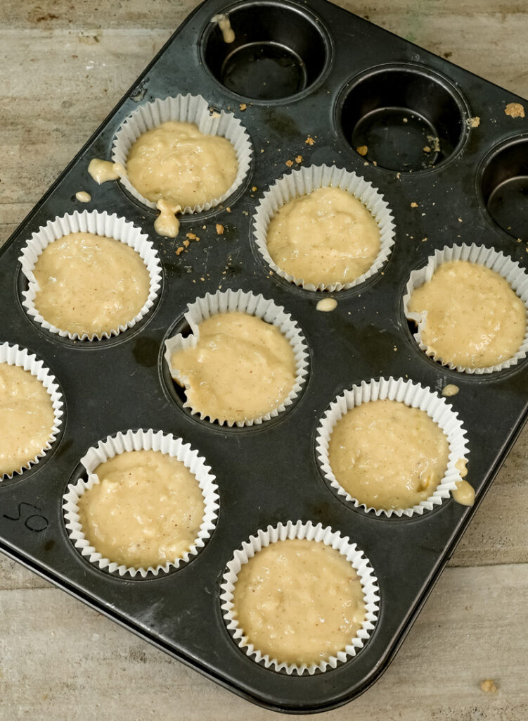 Muffin tin filled with oatmeal batter ready for baking