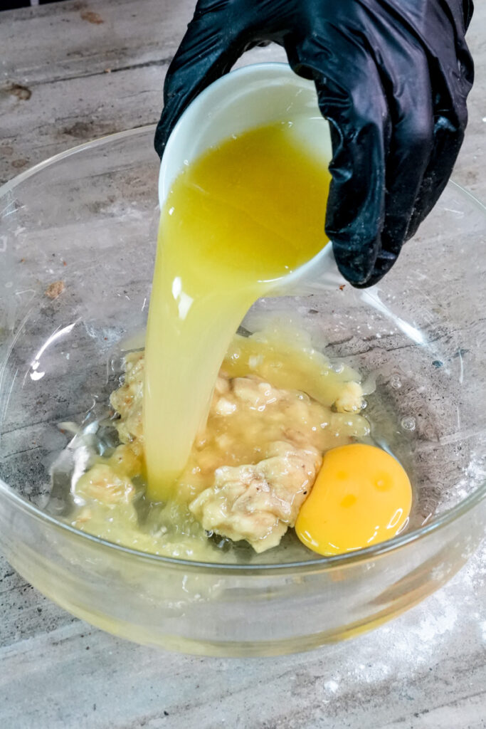 Pouring oil into banana muffin wet ingredients