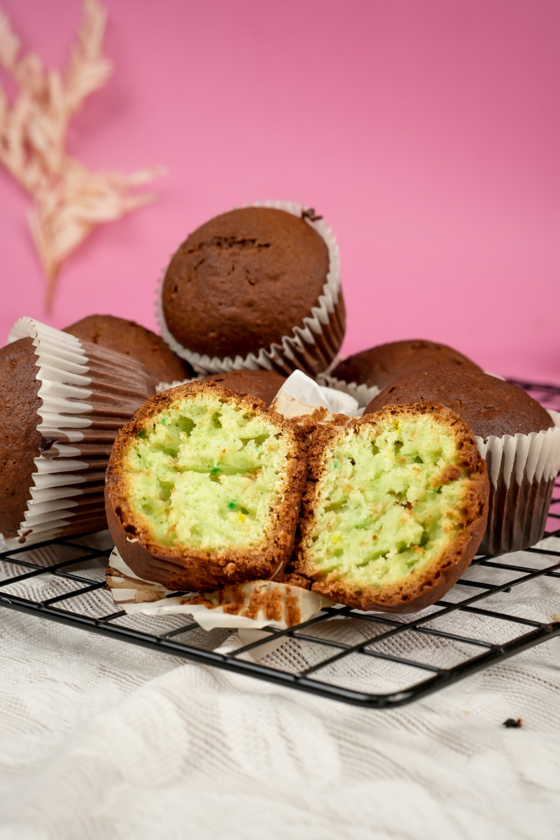 Sliced pistachio muffin showing bright green interior