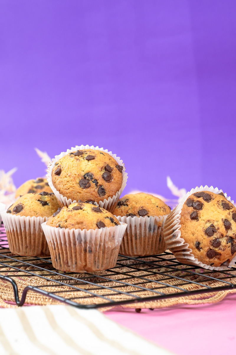 Stacked banana protein muffins with chocolate chips.