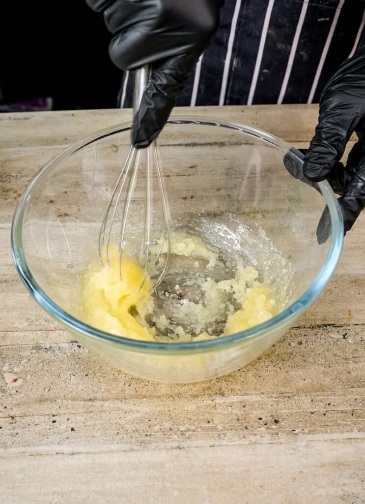Whisking sugar and oil for coffee cake muffin batter.