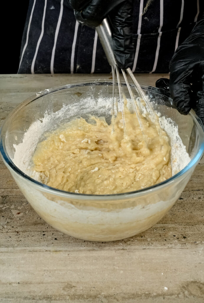 Whisking oatmeal muffin batter until combined