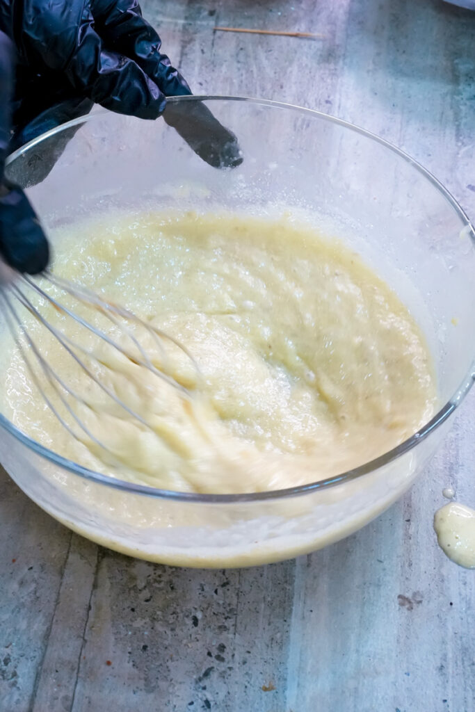 Whisking wet ingredients for banana chocolate chip muffins