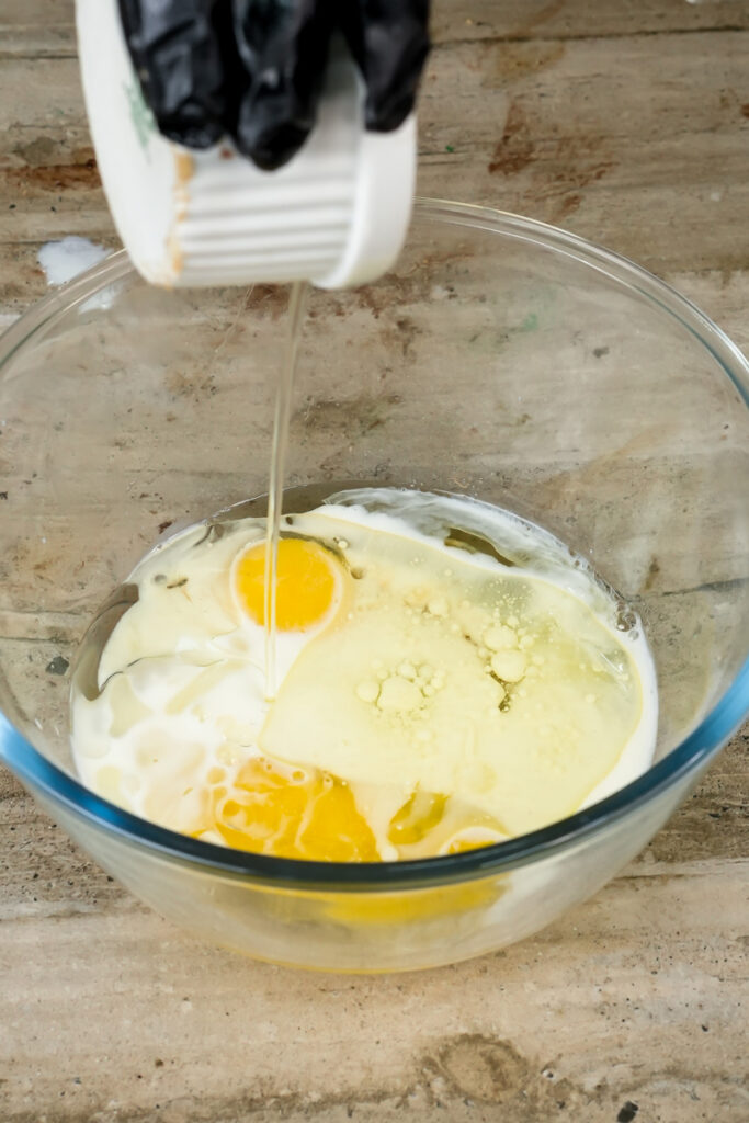 Adding vanilla extract to wet ingredients for pistachio muffins
