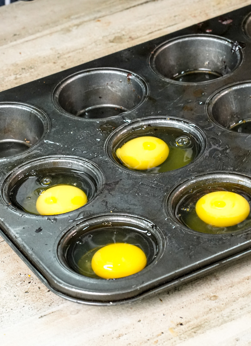 Raw egg yolks in muffin tin ready for baking