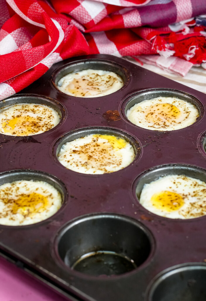 Freshly baked muffin tin eggs with red checkered cloth