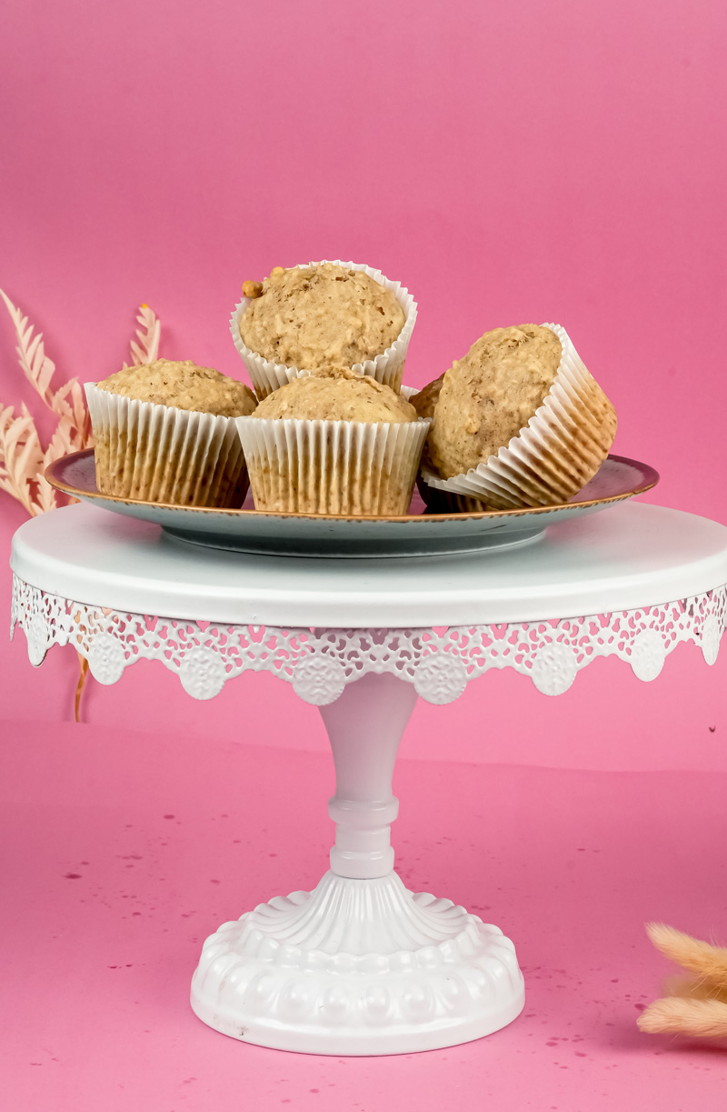 Freshly baked oatmeal muffins on decorative cake stand
