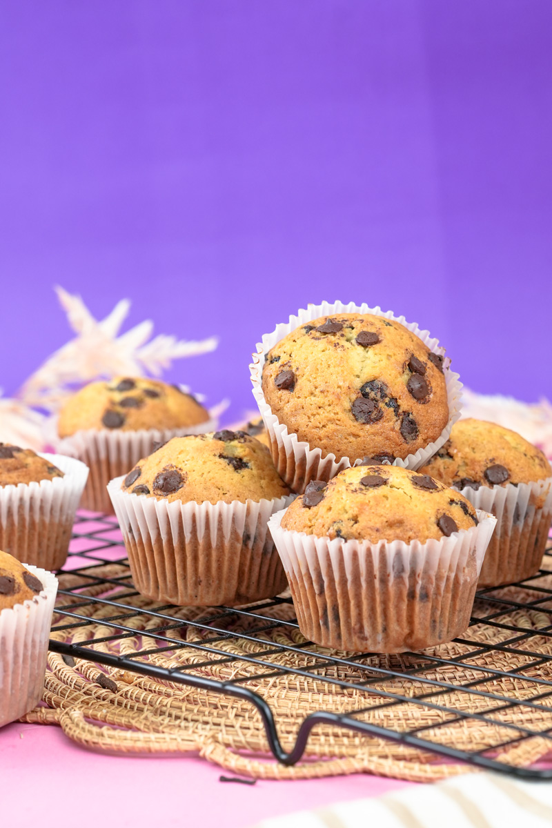 Close-up of banana protein chocolate chip muffins on a wire rack.