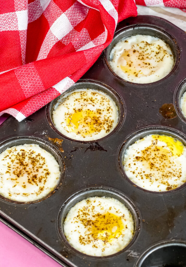Perfectly cooked egg cups in muffin tin with seasoning