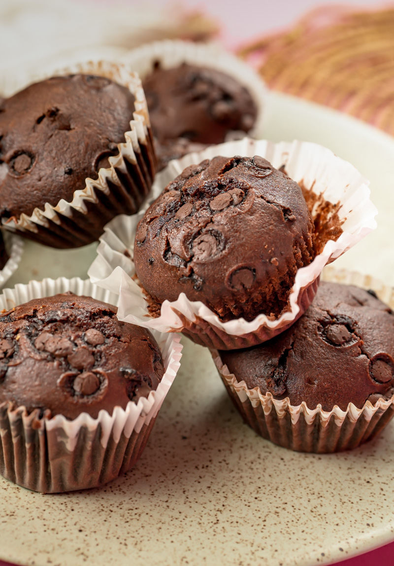 Close-up of moist double chocolate muffins with bite taken