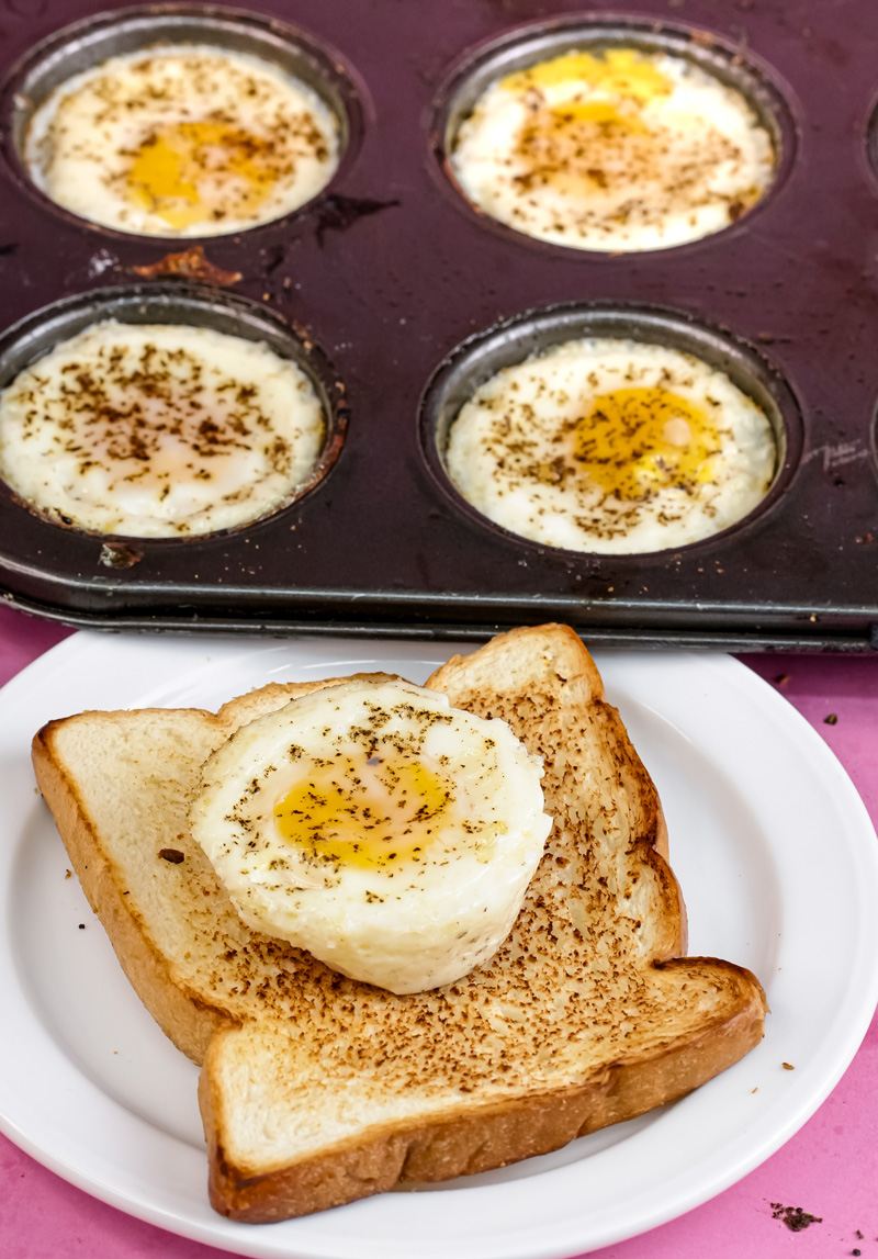 Closeup of muffin tin eggs with one on toast