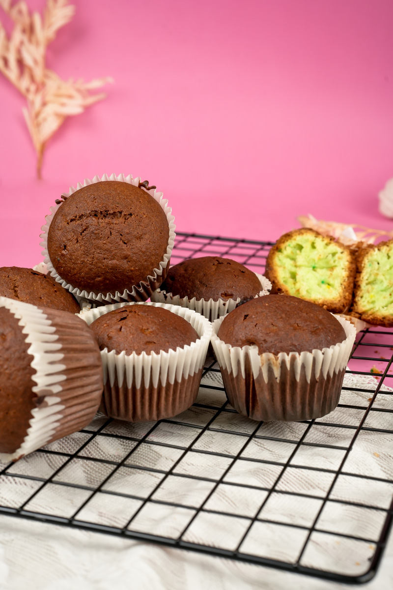 pistachio muffins with green interior on cooling rack
