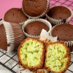 Pistachio muffins with one cut open on wire rack